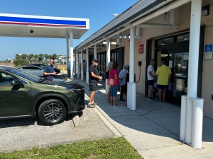 Customers form a line outside the Patrick Space Force Base Express after Hurricane Milton.