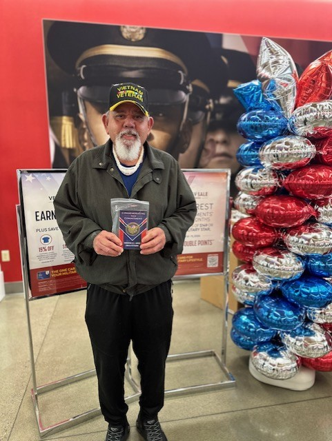 A retired Vietnam Veteran with his commemorative Veterans Day coin at the Fort Lewis Exchange.