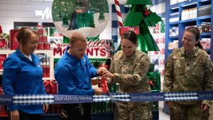 Four people cut the ribbon on the Bath & Body Works at the Joint Base Andrews Exchange.