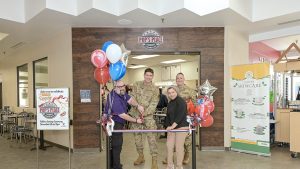 Four people cutting the ribbon at Pop's Place at Selfridge ANGB Exchange.